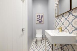 a bathroom with a white sink and a toilet at Beautiful large luxury home in London in Sidcup