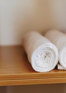 a bunch of rolled towels on a wooden shelf at Penzion Adien in Chvalšiny