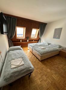 a bedroom with two beds and a flat screen tv at App Bovec in Bovec +3 photos