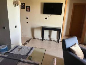 Μια τηλεόραση ή/και κέντρο ψυχαγωγίας στο Appartement avec Solarium Privé au Vizir Résidence Prestigieuse avec Accès au Parc