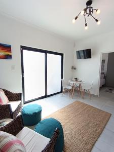 a living room with a couch and a table at Silver Oaks Luxury Guest Cottage in Langebaan
