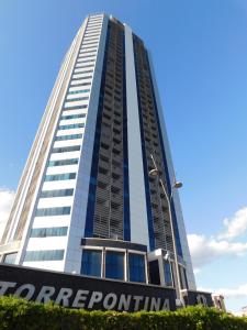 a tall building with a corporate sign in front of it at CityView in Latina