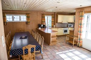 a kitchen with a table and a table and chairs at Big Holiday House South of Norway, by the Osean in Gjeving