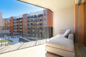 a living room with a couch and a large window at Luxury Apartment con Terrazza, Palestra, CoWork & Box Privato in Milan