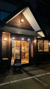 a store with a sign in the window at night at irodori in Matsumoto