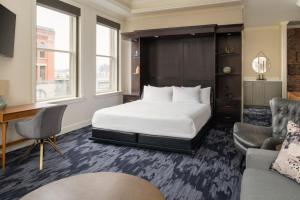 a hotel room with a bed and a desk at Courtyard Tacoma Downtown in Tacoma