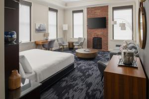 a hotel room with a bed and a fireplace at Courtyard Tacoma Downtown in Tacoma