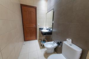 a small bathroom with a toilet and a sink at Olympic Inn Casablanca in Casablanca