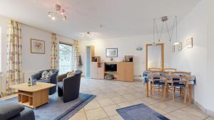 a living room with a couch and a table at Villa Strandburg in Binz