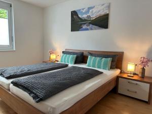 a bedroom with a large bed with two lamps at Ferienwohnung Bodenseeblick in Hagnau