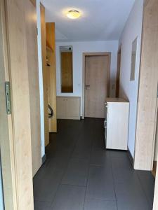 an empty room with a hallway with a refrigerator at Ferienwohnung Bodenseeblick in Hagnau