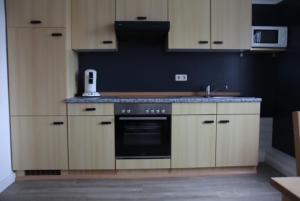 a kitchen with white cabinets and a stove top oven at 3-Raum Ferienwohnung "Scheppler" in Rabel