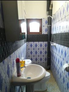 a bathroom with a sink and a toilet at Le Séjour in Yaoundé
