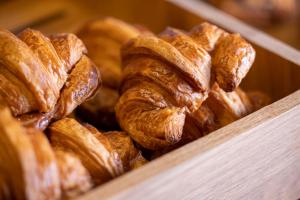 a box filled with croissants and croissantsearcher at Hotel D - Strasbourg in Strasbourg +74 photos