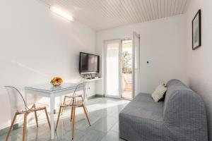 a living room with a couch and a table and a tv at Apartments Tauzer in Mandre