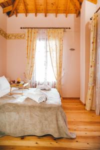 a bedroom with a large bed in front of a window at The Traditional House of Molivos in Mythimna