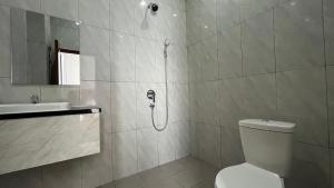 e bagno con doccia, servizi igienici e lavandino. di RedDoorz Premium at Jalan Diponegoro Lampung a Bandar Lampung