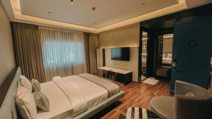 a bedroom with a large bed and a television at Radhe Upavan Resort in Ahmedabad