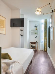 Postel nebo postele na pokoji v ubytování Hôtel Bordeaux Clémenceau by Happyculture