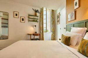 Postel nebo postele na pokoji v ubytování Hôtel Bordeaux Clémenceau by Happyculture
