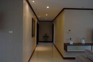 a hallway with a couch and a table in a room at 3 Bedrooms Apartment in Ekkamai,Sukhumvit in Khlong Toei +2 photos