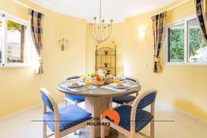 a dining room with a round table and chairs at #214 Vivenda 3 Quartos by Home Holidays in Branqueira