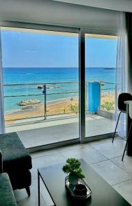 a living room with a view of the ocean at Stegna Sea & Sun in Archangelos