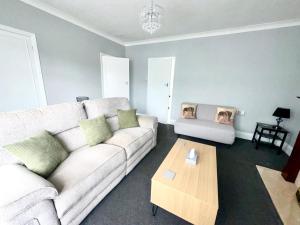 a living room with a couch and a coffee table at M1 Link 2 bed house up to 4 people, free parking,wifi,M1,transport links,garden in Sutton in Ashfield