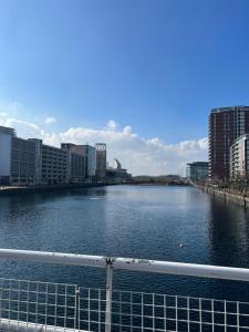 a view of a river in a city with buildings at 2Bed apartment in Media city within walking distance from Old Trafford Stadium in Manchester