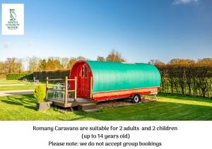 a red barn with a green tarp on it at Glamping at South Lytchett Manor in Poole