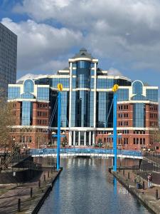 a bridge over a river in a city with buildings at 2Bed apartment in Media city within walking distance from Old Trafford Stadium in Manchester