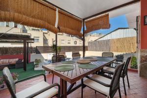 a wooden table and chairs on a patio at Goleta in El Puerto de Santa María