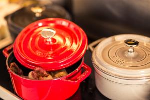 a red container with food in it on a stove at Hôtel Diana Dauphine in Strasbourg