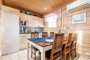 a kitchen with a dining room table and chairs at Lossisaari Tourist Center in Keitele