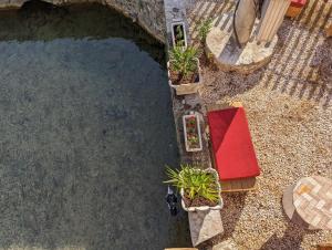 an overhead view of a pool of water with plants at National Monument Konak in Stolac