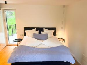 a bedroom with a bed with a blue and white comforter at Garden Apartment Untermühle in Bressanone