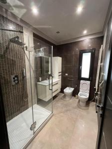 a bathroom with a glass shower and a toilet at Appartamento un mare di fiori in Ventimiglia