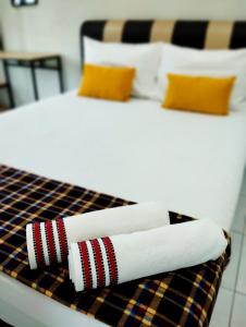 a close up of a bed with towels on it at Mukmin 2 Stay in Malacca