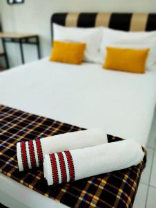 a close up of a bed with towels on it at Mukmin 2 Stay in Melaka