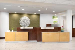 an office lobby with a reception desk and a chandelier at Fairfield Inn & Suites by Marriott Key West at The Keys Collection in Key West