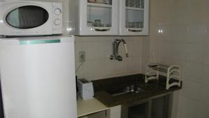 a small kitchen with a sink and a microwave at Apartamento Benevenuto Copacabana in Rio de Janeiro