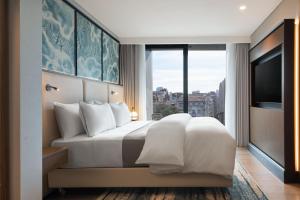 a bedroom with a white bed and a large window at The Westin Istanbul Nisantasi in Istanbul