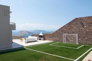 a house with a soccer field in the yard at Kaerati Villa Aegina in Aegina Town