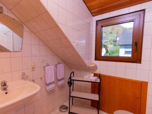 a bathroom with a sink and a window at Bed & Breakfast Sandra Müller in Burg (an der Mosel)