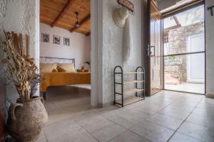 a bedroom with a bed and a vase on the floor at Το σπιτι του μελισσοκομου in Análipsis +26 photos