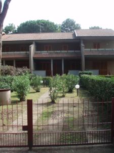 a building with a fence in front of it at VILLA ORATA 8b in Principina a Mare