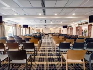 a large room with rows of chairs in it at Mercure Bordeaux Chateau Chartrons in Bordeaux