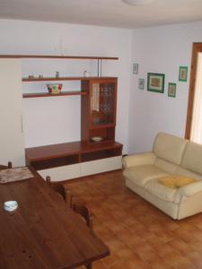 a living room with a couch and a table at VILLA ORATA 8b in Principina a Mare