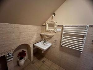 a bathroom with a sink and a mirror at Hotelik Orański in Stronie Śląskie