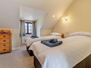 a bedroom with three beds with towels on them at 3 Bed in Repps with Bastwick 94054 in Potter Heigham